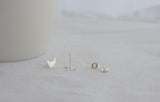 silver chicken silhouette earrings on a white background